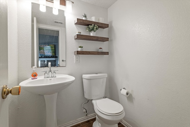 bathroom with hardwood / wood-style floors and toilet