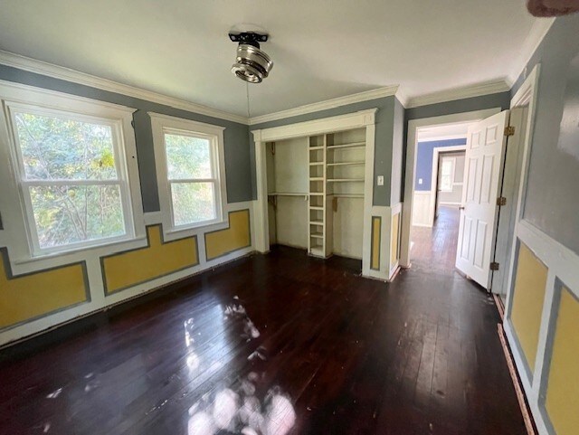 unfurnished room featuring dark hardwood / wood-style flooring and crown molding