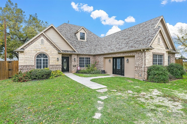 view of front of property with roof with shingles, a front yard, and fence