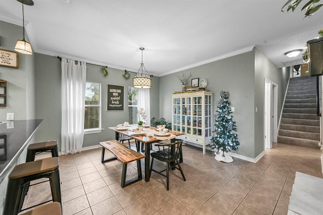 dining room with tile patterned flooring and ornamental molding