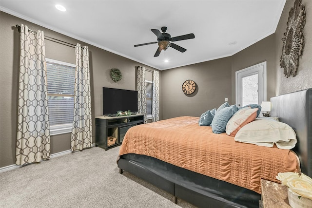 carpeted bedroom featuring ceiling fan and crown molding