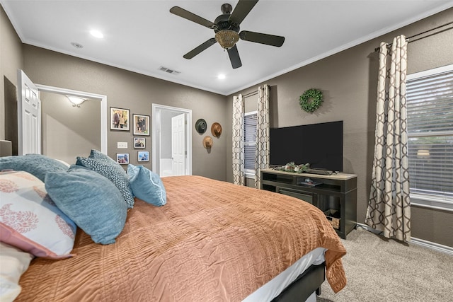 carpeted bedroom with ceiling fan and crown molding