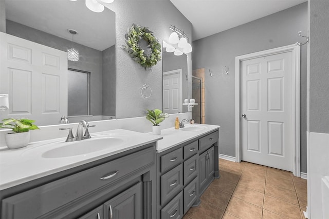 bathroom featuring tile patterned floors, vanity, and vaulted ceiling