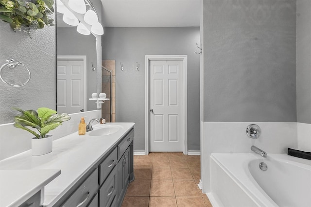 bathroom featuring tile patterned floors, a bathtub, and vanity