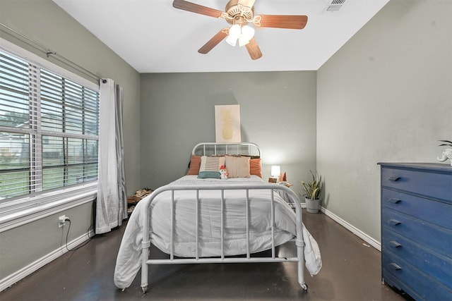 bedroom featuring multiple windows and ceiling fan