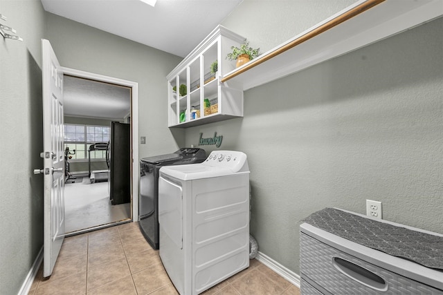 washroom with light tile patterned flooring and independent washer and dryer