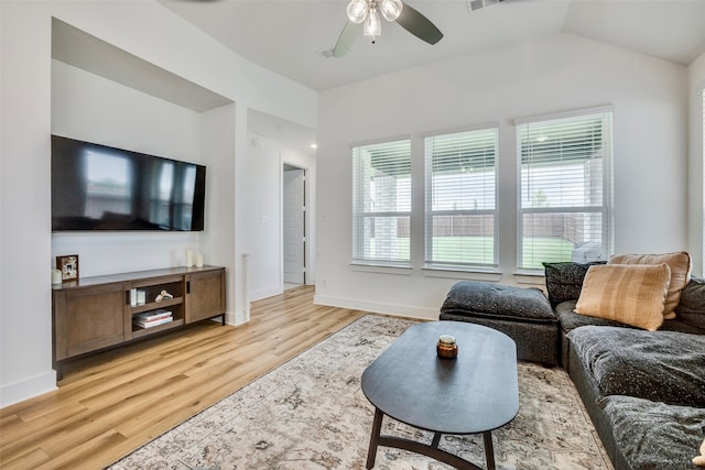 living room with ceiling fan, lofted ceiling, and light wood-type flooring