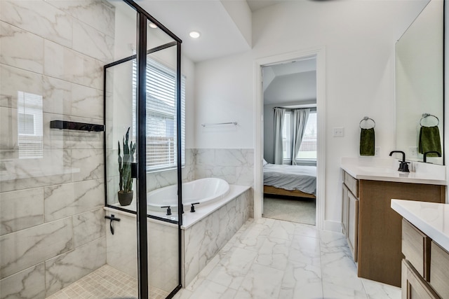 bathroom featuring plenty of natural light, vanity, and independent shower and bath