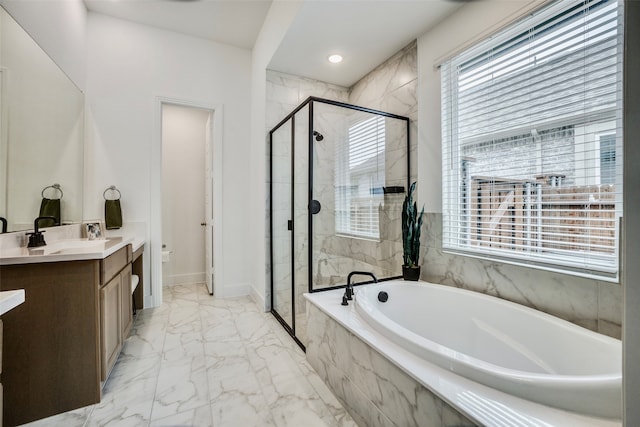 full bathroom with vanity, toilet, shower with separate bathtub, and a wealth of natural light