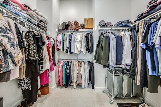 spacious closet featuring light carpet