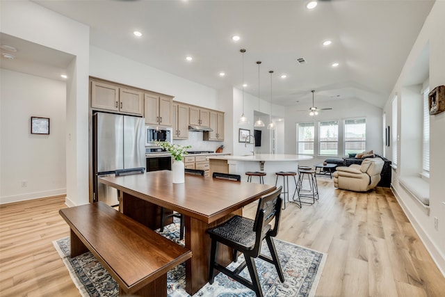 dining room featuring light hardwood / wood-style floors, ceiling fan, and lofted ceiling