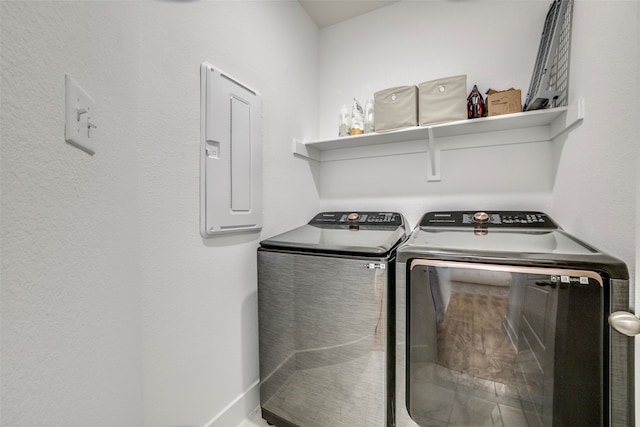 clothes washing area with electric panel and washing machine and clothes dryer