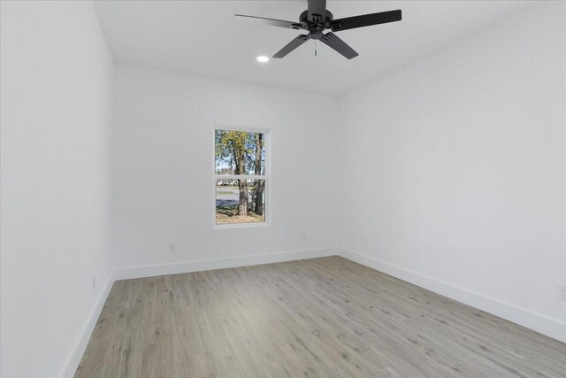 unfurnished room with ceiling fan and light wood-type flooring