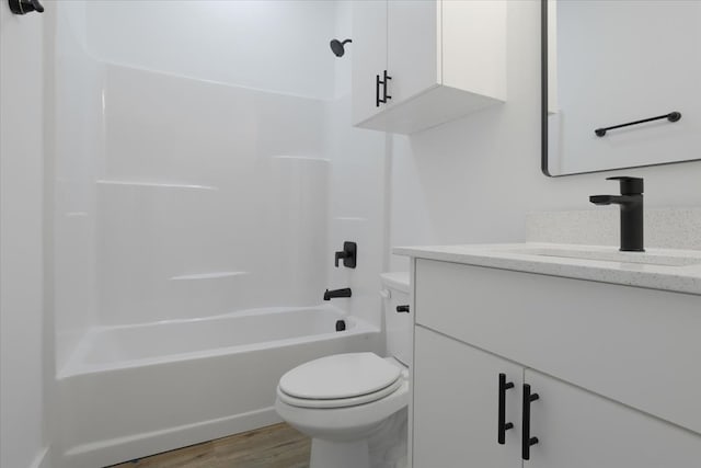 full bathroom featuring vanity, wood-type flooring, bathtub / shower combination, and toilet