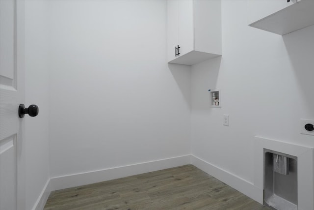 washroom featuring hookup for an electric dryer, light hardwood / wood-style floors, cabinets, and washer hookup