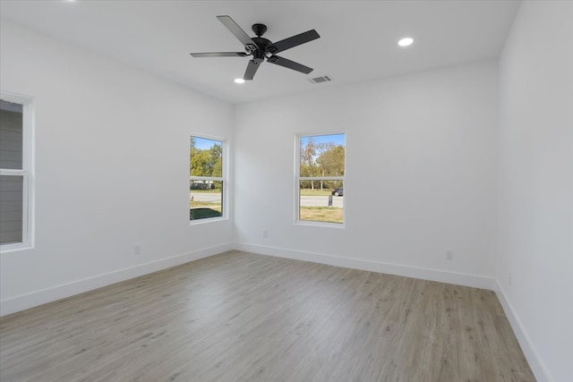 spare room featuring light hardwood / wood-style flooring and ceiling fan