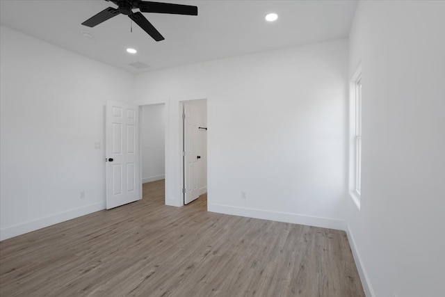 unfurnished room with ceiling fan and light wood-type flooring