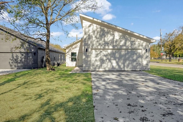 rear view of house with a lawn and a garage