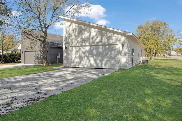 view of property exterior with central AC unit, a garage, and a yard