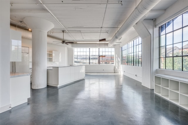 interior space with a wealth of natural light and ceiling fan