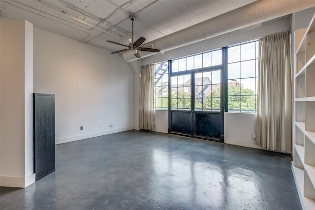 empty room with a wealth of natural light and ceiling fan