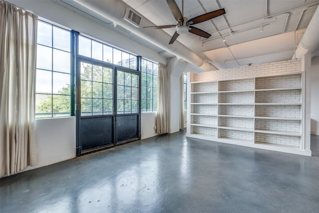 interior space with ceiling fan