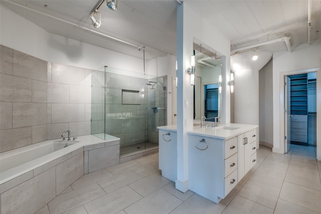 bathroom with tile patterned floors, vanity, track lighting, and shower with separate bathtub