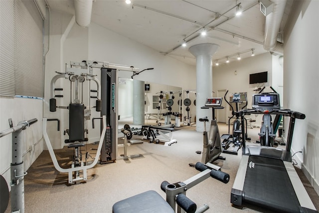 gym with a towering ceiling