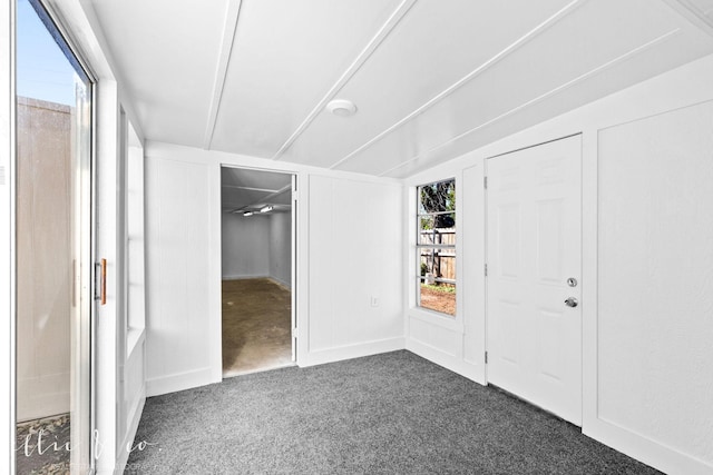 unfurnished bedroom featuring carpet floors and lofted ceiling