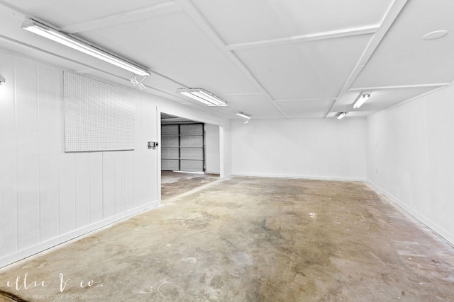 basement featuring wood walls