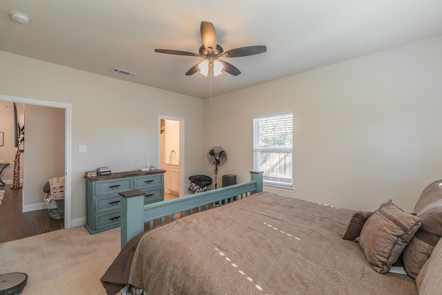 bedroom featuring wood-type flooring, ensuite bath, and ceiling fan