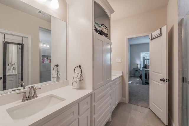 bathroom with tile patterned floors and vanity