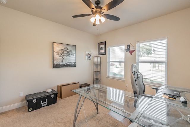 carpeted home office featuring ceiling fan