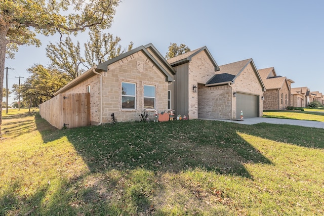 view of front of house featuring a garage and a front lawn