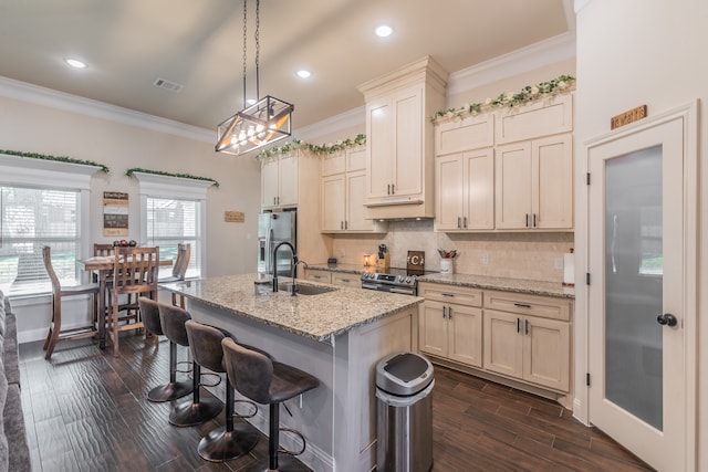 kitchen featuring dark hardwood / wood-style flooring, stainless steel appliances, and light stone counters