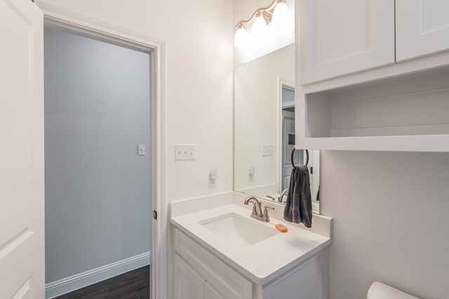 bathroom with hardwood / wood-style floors and vanity