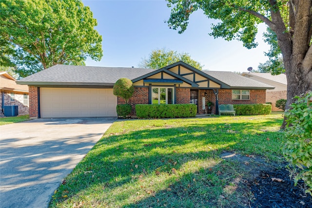 single story home featuring a front lawn and a garage