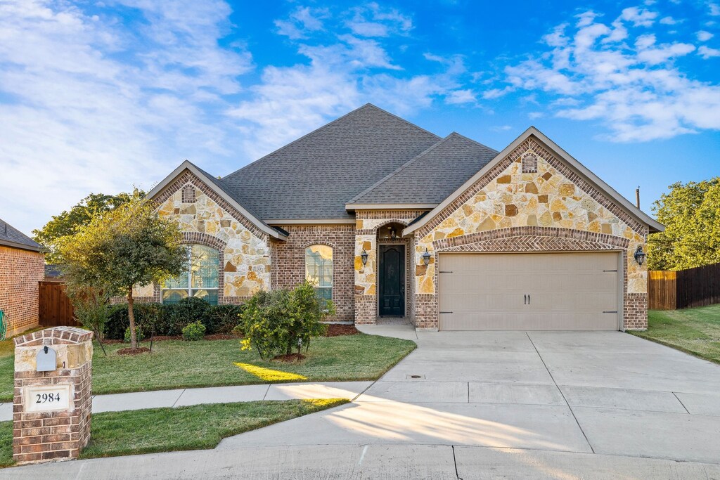 view of front of home with a garage and a front yard