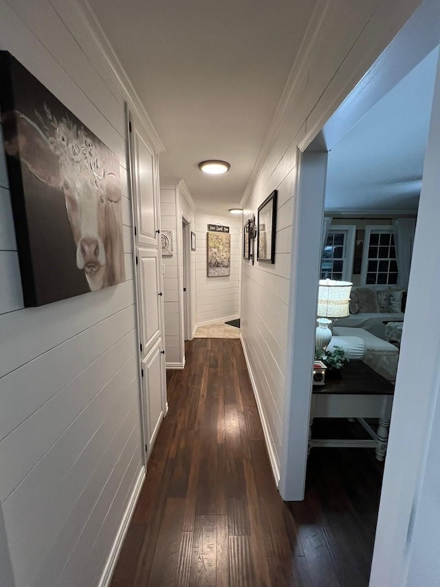 208 Cedar Ln, Burleson, TX 76028 - hallway with dark wood finished floors, crown molding, wood walls, and baseboards
