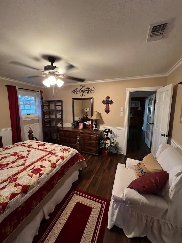 208 Cedar Ln, Burleson, TX 76028 - bedroom with wainscoting, dark wood-type flooring, crown molding, and a ceiling fan
