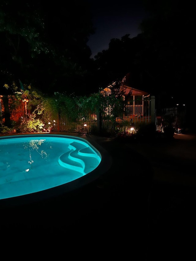 208 Cedar Ln, Burleson, TX 76028 - pool at night with fence