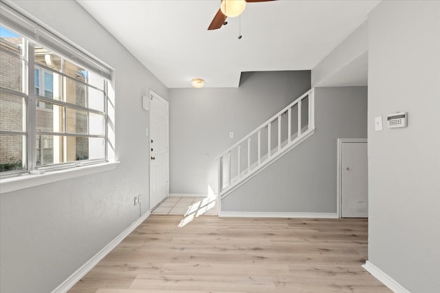 foyer entrance featuring ceiling fan and light hardwood / wood-style floors