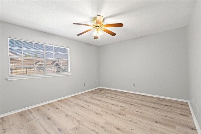 spare room with light hardwood / wood-style floors and ceiling fan