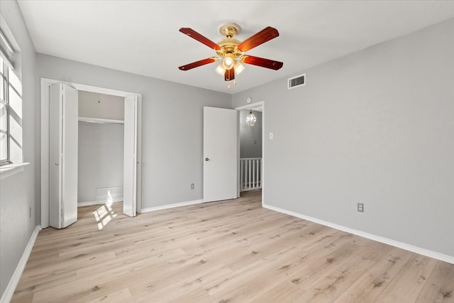 unfurnished bedroom featuring ceiling fan, a closet, and light hardwood / wood-style floors