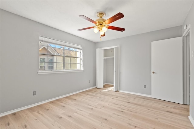 unfurnished bedroom featuring ceiling fan, light wood-type flooring, and a closet