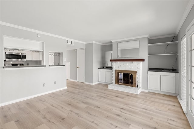 unfurnished living room featuring a fireplace, light hardwood / wood-style floors, and ornamental molding