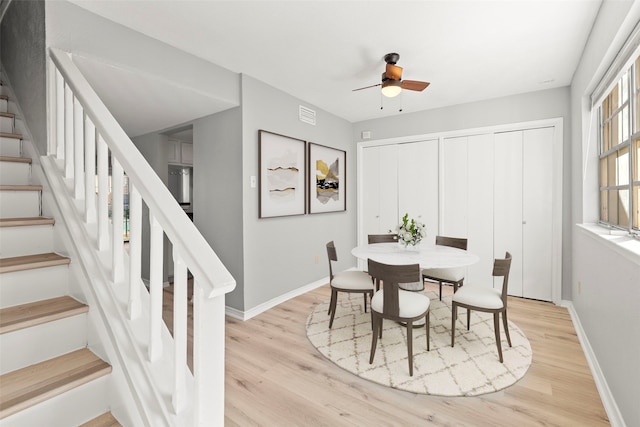 dining space featuring ceiling fan and light wood-type flooring