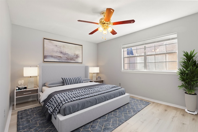 bedroom with ceiling fan and light hardwood / wood-style flooring