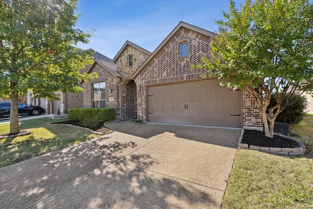 view of front of house with a garage, stone siding, brick siding, and concrete driveway