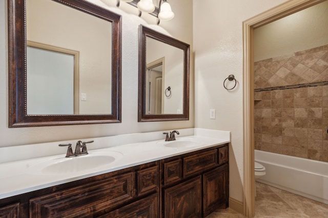 full bathroom featuring shower / bathtub combination, double vanity, a sink, and toilet